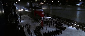 Movie still from “K-19: The Widowmaker” (2002), directed by Kathryn Bigelow – A group of people standing in front of a large ship; Extreme Wide shot, High angle