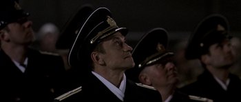 Movie still from “K-19: The Widowmaker” (2002), directed by Kathryn Bigelow – Two men in military uniforms are looking up at the sky; Medium shot, Low angle