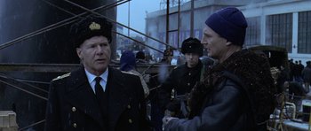 Movie still from “K-19: The Widowmaker” (2002), directed by Kathryn Bigelow – Two men are talking to each other outside; Medium shot, Over the shoulder angle