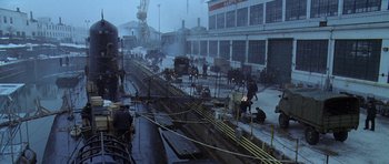 Movie still from “K-19: The Widowmaker” (2002), directed by Kathryn Bigelow – A group of men working on a train track; Extreme Wide shot, High angle