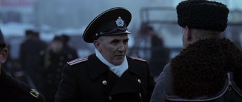 Movie still from “K-19: The Widowmaker” (2002), directed by Kathryn Bigelow – An old man in a uniform is standing in the fog; Close Up shot, Low angle