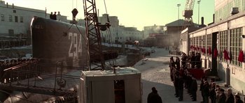 Movie still from “K-19: The Widowmaker” (2002), directed by Kathryn Bigelow – People are standing in the street next to a train; Extreme Wide shot, High angle