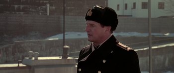 Movie still from “K-19: The Widowmaker” (2002), directed by Kathryn Bigelow – A man in a military uniform wearing a hat; Medium shot, Low angle