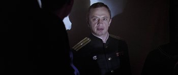 Movie still from “K-19: The Widowmaker” (2002), directed by Kathryn Bigelow – A person wearing a uniform; Close Up shot, Over the shoulder angle