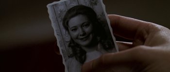 Movie still from “K-19: The Widowmaker” (2002), directed by Kathryn Bigelow – A person holding an old photo of a woman; Extreme Close Up shot, High angle