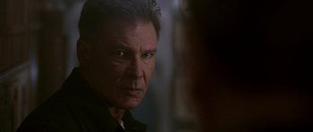 Movie still from “K-19: The Widowmaker” (2002), directed by Kathryn Bigelow – A person wearing a black shirt; Close Up shot, Over the shoulder angle