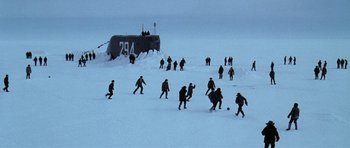 Movie still from “K-19: The Widowmaker” (2002), directed by Kathryn Bigelow – A group of men playing soccer in the snow; Extreme Wide shot, High angle