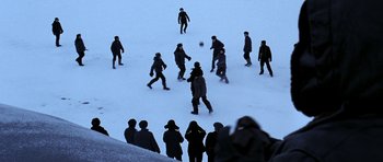 Movie still from “K-19: The Widowmaker” (2002), directed by Kathryn Bigelow – A group of people playing soccer in the snow; Extreme Wide shot, High angle