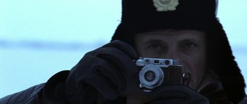 Movie still from “K-19: The Widowmaker” (2002), directed by Kathryn Bigelow – A man holding a camera up to his face; Close Up shot, Low angle