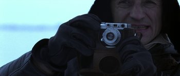 Movie still from “K-19: The Widowmaker” (2002), directed by Kathryn Bigelow – A person holding an old fashioned camera in their hands; Extreme Close Up shot, Low angle