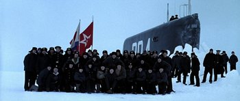 Movie still from “K-19: The Widowmaker” (2002), directed by Kathryn Bigelow – A group of people standing in front of an airplane; Extreme Wide shot, High angle