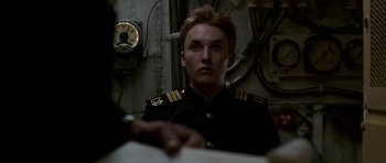 Movie still from “K-19: The Widowmaker” (2002), directed by Kathryn Bigelow – A man in a uniform is looking at the camera; Close Up shot, Low angle