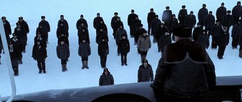 Movie still from “K-19: The Widowmaker” (2002), directed by Kathryn Bigelow – A group of people standing in the middle of a snow covered field; Wide shot, High angle