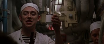 Movie still from “K-19: The Widowmaker” (2002), directed by Kathryn Bigelow – A man holding a cup in his hand; Close Up shot, Low angle