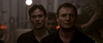 Movie still from “K-19: The Widowmaker” (2002), directed by Kathryn Bigelow – A group of men standing next to each other in a room; Close Up shot, Low angle