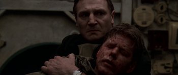 Movie still from “K-19: The Widowmaker” (2002), directed by Kathryn Bigelow – A man holding a knife over another man's face; Close Up shot, Over the shoulder angle