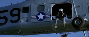 Movie still from “K-19: The Widowmaker” (2002), directed by Kathryn Bigelow – A man sitting in the cockpit of an airplane; Wide shot, Low angle