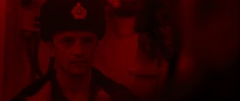 Movie still from “K-19: The Widowmaker” (2002), directed by Kathryn Bigelow – A man wearing a uniform and a hat; Close Up shot, Over the shoulder angle