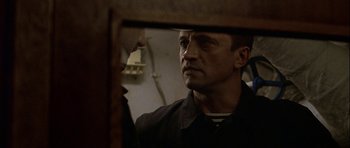 Movie still from “K-19: The Widowmaker” (2002), directed by Kathryn Bigelow – A person looking at a mirror; Close Up shot, Over the shoulder angle