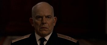 Movie still from “K-19: The Widowmaker” (2002), directed by Kathryn Bigelow – An older man wearing a uniform and a black tie; Close Up shot, Low angle
