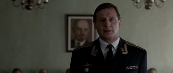 Movie still from “K-19: The Widowmaker” (2002), directed by Kathryn Bigelow – A man in a uniform standing in front of a picture of lenin; Close Up shot, Low angle