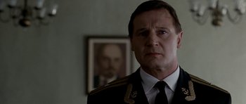 Movie still from “K-19: The Widowmaker” (2002), directed by Kathryn Bigelow – A person wearing a suit and tie; Close Up shot, Low angle