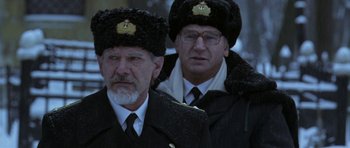 Movie still from “K-19: The Widowmaker” (2002), directed by Kathryn Bigelow – A couple of men in black jackets and hats; Close Up shot, Low angle
