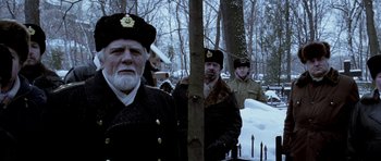 Movie still from “K-19: The Widowmaker” (2002), directed by Kathryn Bigelow – A group of men standing next to each other in the snow; Medium shot, Low angle