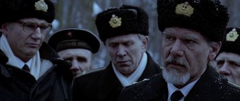 Movie still from “K-19: The Widowmaker” (2002), directed by Kathryn Bigelow – A group of men standing next to each other; Close Up shot, Over the shoulder angle