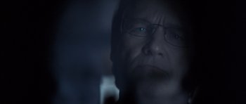 Movie still from “K-PAX” (2001), created by Robert Cochran – A man wearing glasses looking at the camera; Extreme Close Up shot, Over the shoulder angle