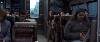 Movie still from “K-PAX” (2001), created by Robert Cochran – A group of people sitting in a train car; Wide shot, High angle