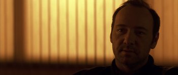 Movie still from “K-PAX” (2001), created by Robert Cochran – A person wearing a black shirt; Close Up shot, Low angle