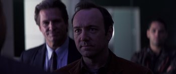 Movie still from “K-PAX” (2001), created by Robert Cochran – A man in a brown jacket and a man in a blue tie; Close Up shot, Over the shoulder angle