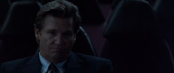 Movie still from “K-PAX” (2001), created by Robert Cochran – A person wearing a suit and tie; Close Up shot, Over the shoulder angle