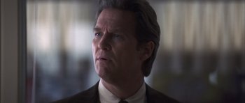 Movie still from “K-PAX” (2001), created by Robert Cochran – A person wearing a suit and tie; Close Up shot, Low angle