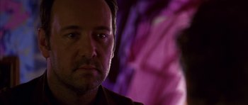 Movie still from “K-PAX” (2001), created by Robert Cochran – A person wearing a brown shirt; Close Up shot, Over the shoulder angle