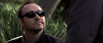 Movie still from “K-PAX” (2001), created by Robert Cochran – A person wearing sunglasses; Close Up shot, Low angle