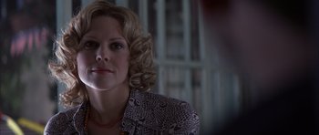 Movie still from “K-PAX” (2001), created by Robert Cochran – A person with curly blonde hair; Close Up shot, Over the shoulder angle