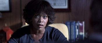 Movie still from “K-PAX” (2001), created by Robert Cochran – A person sitting in a chair; Close Up shot, Over the shoulder angle