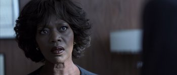 Movie still from “K-PAX” (2001), created by Robert Cochran – An older black woman with short curly hair; Close Up shot, Over the shoulder angle