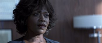 Movie still from “K-PAX” (2001), created by Robert Cochran – A person with short black hair; Close Up shot, Over the shoulder angle