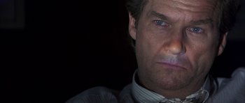 Movie still from “K-PAX” (2001), created by Robert Cochran – A man's face in the dark; Close Up shot, Low angle