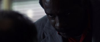 Movie still from “K-PAX” (2001), created by Robert Cochran – A man's face in the dark; Extreme Close Up shot, Over the shoulder angle