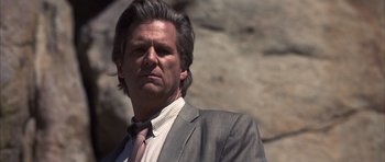 Movie still from “K-PAX” (2001), created by Robert Cochran – A person wearing a suit and tie; Close Up shot, Low angle