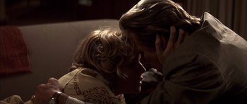 Movie still from “K-PAX” (2001), created by Robert Cochran – A woman and a man are laying on a couch; Close Up shot, High angle