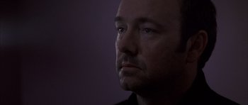 Movie still from “K-PAX” (2001), created by Robert Cochran – A person's face in the dark; Close Up shot, Low angle