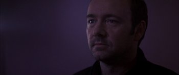 Movie still from “K-PAX” (2001), created by Robert Cochran – A person looking at the camera; Close Up shot, Low angle