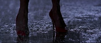 Movie still from “Kalifornia” (1993), directed by Dominic Sena – A woman's foot in high heels in the rain; Extreme Close Up shot, Low angle