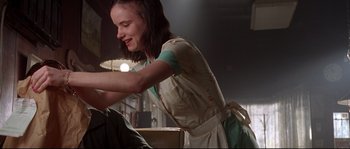 Movie still from “Kalifornia” (1993), directed by Dominic Sena – A woman in an apron smiles at the camera; Close Up shot, Low angle