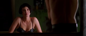 Movie still from “Kalifornia” (1993), directed by Dominic Sena – A woman sitting in front of a mirror in front of a wall; Close Up shot, Over the shoulder angle